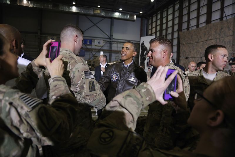 Soldiers take photos as U.S. President Barack Obama shakes hands with troops after delivering remarks at Bagram Air Base in Kabul